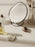 Ferm Living Brass Pond Table Mirror in accessories collection, featuring a round brass frame and reflective surface.