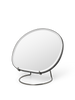 Brass Pond Table Mirror by Ferm Living, a stylish accessory with a round reflective surface and elegant brass frame.
