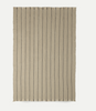 Ferm Living Calm Blanket in soft, neutral fabric, showcasing cozy textured accessories perfect for relaxing home decor.