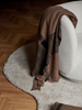 Ferm Living Dry Blanket accessory featuring soft, textured fabric in neutral tones, perfect for cozy home decor.