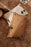 Natural-colored The Park Cushion by Ferm Living, soft textile accessory with subtle pattern and plush texture for home decor.