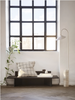 Black Ferm Living Oblique Bench used as stylish seating, showcasing modern design and sleek wooden construction.