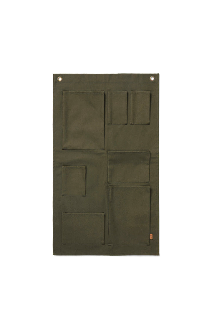 Ferm Living Bark Garden Wall Storage unit mounted on a wall, showcasing its modern design and functional storage space for outdoor use.