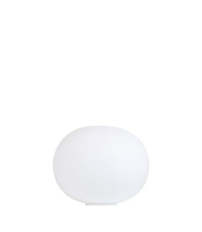 Flos Glo-Ball Basic table lamp with white spherical glass shade and sleek metal base, providing ambient lighting.