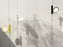 Black OK Suspension Lamp by Flos hanging from ceiling with a sleek, minimalist design for modern lighting.