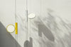 Black OK Suspension Lamp by Flos hanging from a ceiling with a sleek, modern design and smooth, curved shape.