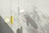 Black OK Suspension Lamp by Flos hanging from a ceiling with a sleek, modern design and smooth, curved shape.