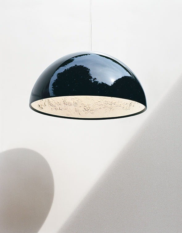 Gold Skygarden suspension lamp by Flos, modern lighting fixture with intricate floral-inspired design, hanging from ceiling.
