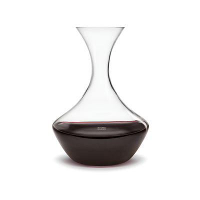 Holmegaard Perfection Carafe with matching holder, elegant glass accessories for serving beverages in a stylish kitchen setting.