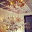 Small antique brass Sputnik chandelier by Jonathan Adler, featuring multiple arms with vintage-inspired light sockets.