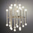 Brass Meurice Chandelier by Jonathan Adler hanging with multiple light bulbs and decorative details in a modern lighting fixture.