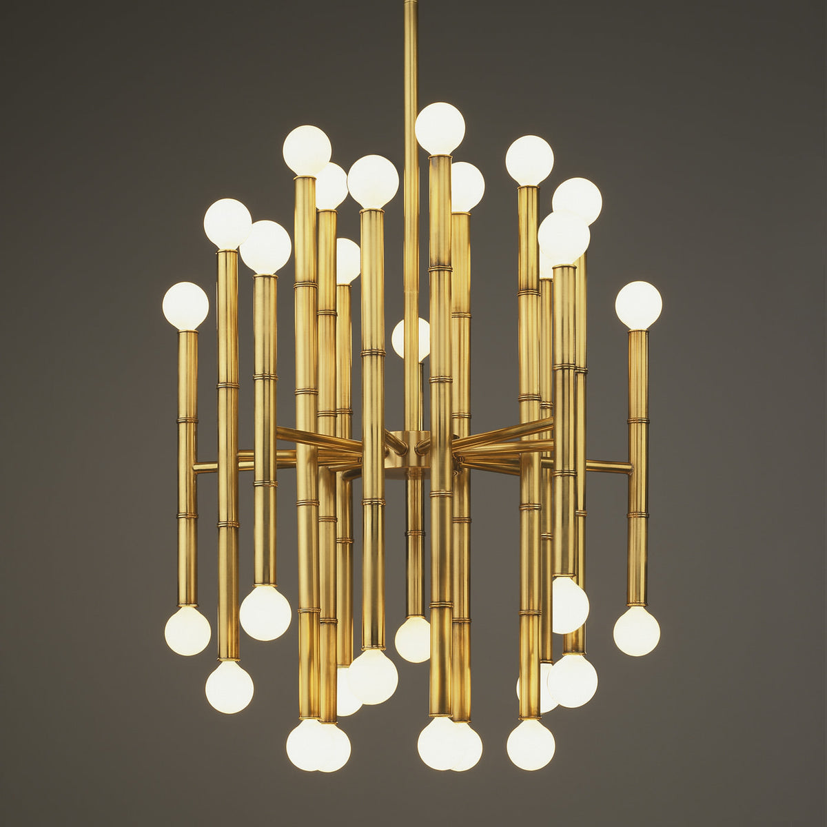 Brass Meurice chandelier by Jonathan Adler showcasing elegant lighting with multiple bulbs and intricate detailing.