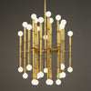 Brass Meurice chandelier by Jonathan Adler showcasing elegant lighting with multiple bulbs and intricate detailing.