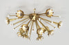 Polished nickel Sputnik flush mount ceiling light by Jonathan Adler with multiple light arms radiating outward.