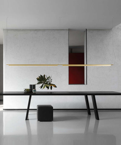 Luceplan Compendium Suspension Lamp in aluminum with warm 2700K lighting, modern lighting fixture hanging from ceiling.