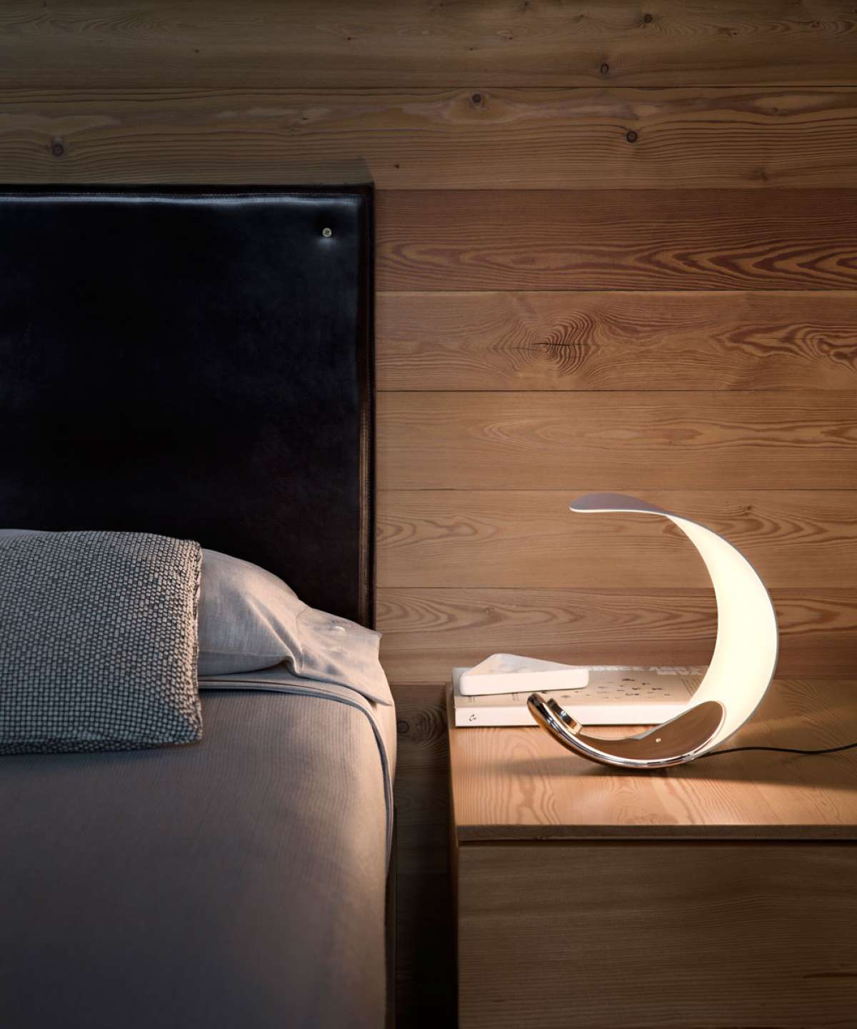 Luceplan Curl Table lighting with sleek, modern design featuring a curved glass shade and minimalist base.