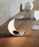 Luceplan Curl Table lighting with sleek, curved design, featuring a modern lamp base and shade for contemporary interior decor.