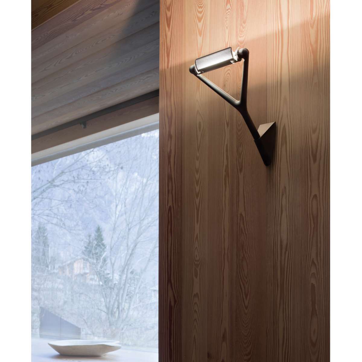 Luceplan Lola Wall Lamp, modern lighting fixture with sleek design, mounted on a wall in a contemporary interior setting.