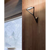 Luceplan Lola Wall Lamp, modern lighting fixture with sleek design, mounted on a wall in a contemporary interior setting.
