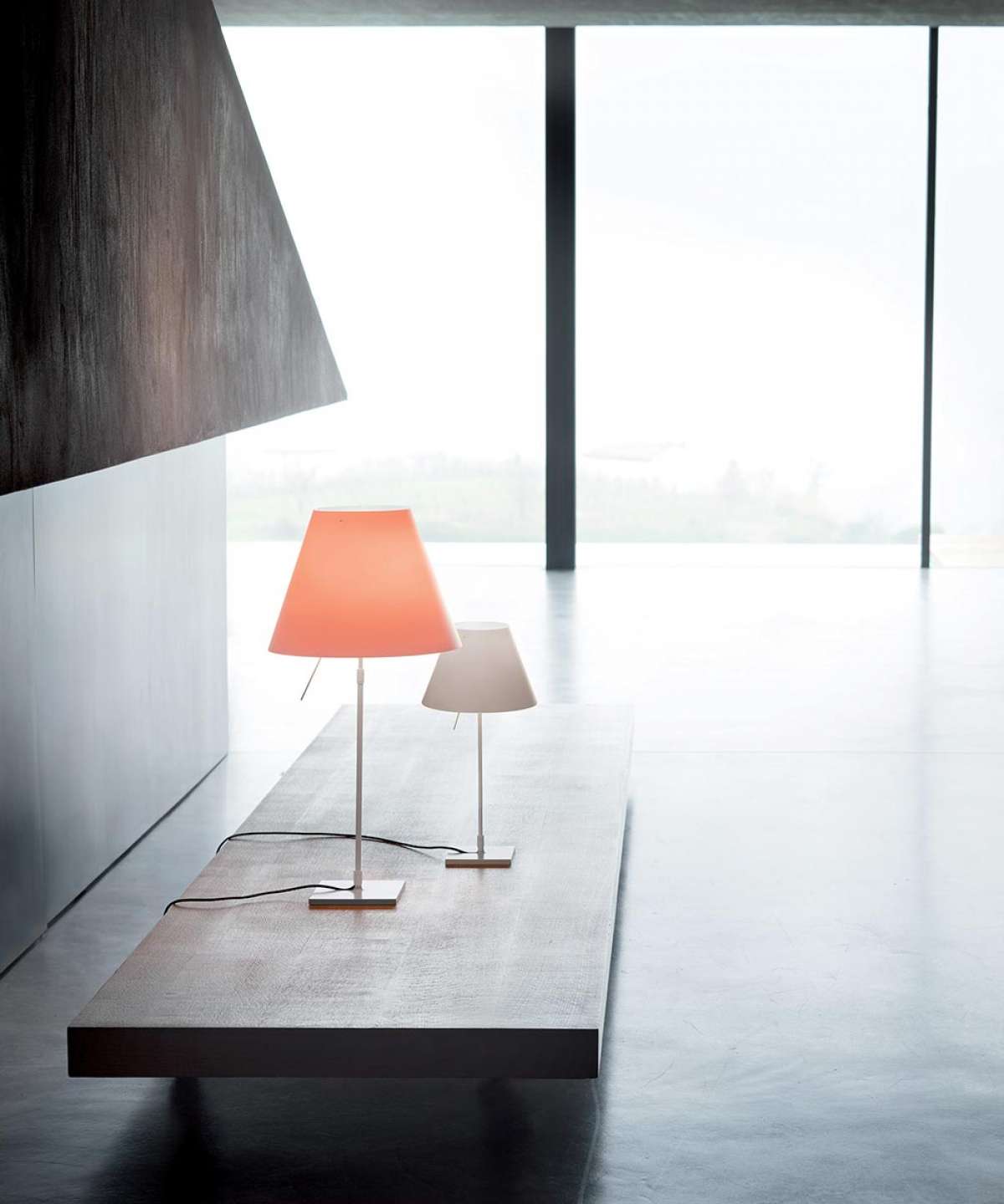 Costanza Table Lamp by Luceplan with white aluminum finish and on/off switch, modern lighting design, on a flat surface.