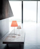 Costanza Table Lamp by Luceplan with white aluminum finish and on/off switch, modern lighting design, on a flat surface.