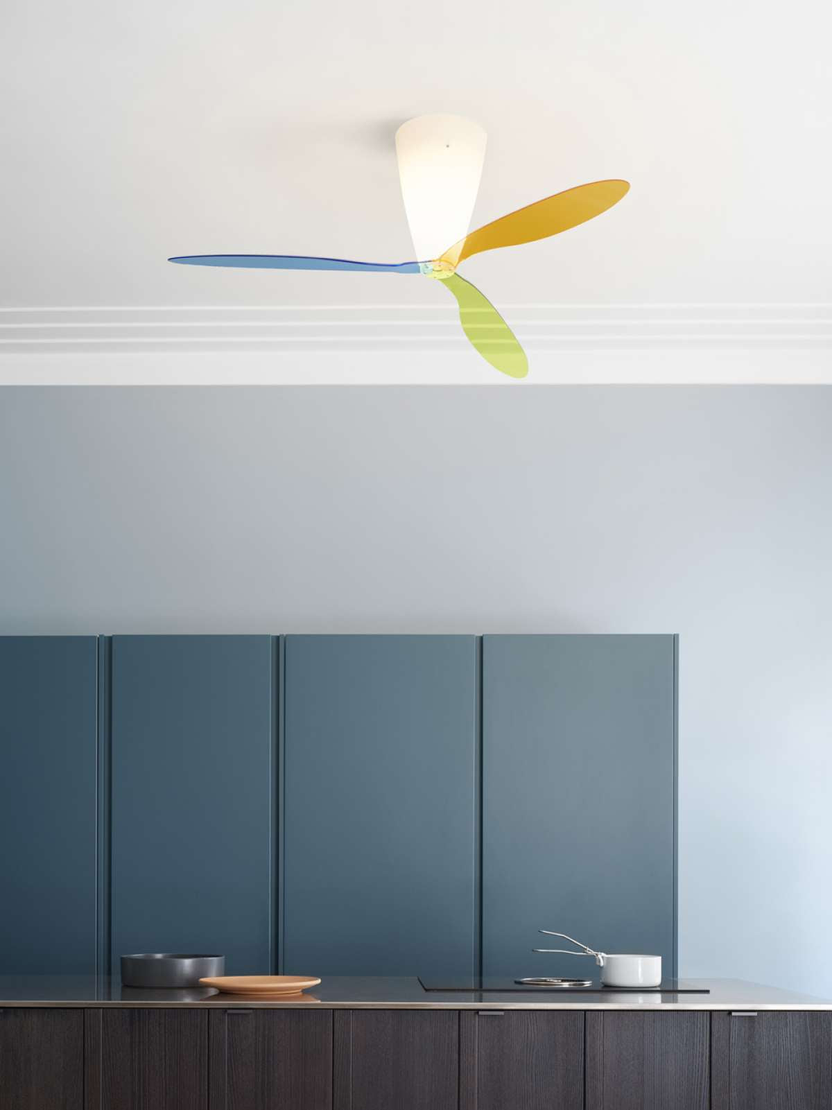 Luceplan Blow ceiling fan, transparent lighting fixture with sleek modern design, mounted on ceiling in contemporary space