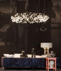 Copper Heracleum III The Big O by Moooi lighting fixture with multiple branching arms and illuminated bulbs.