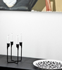 Heima 4-armed Candlestick by Normann Copenhagen, modern accessories with four arms, made of sleek, polished material.