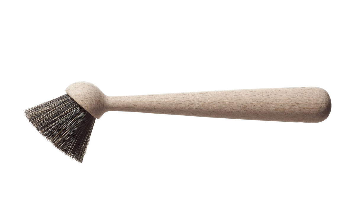 Washing-up brush by Normann Copenhagen, a stylish kitchen accessory with a wooden handle and durable bristles.