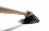 Washing-up brush by Normann Copenhagen, with wooden handle and bristles, designed for kitchen dishwashing accessories.