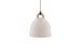 Small sand-colored Bell Lamp by Normann Copenhagen, stylish modern lighting fixture with a smooth, rounded design.