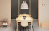 Small sand-colored Bell Lamp by Normann Copenhagen, a modern lighting fixture with a smooth, rounded design.