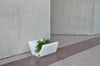 Red Otto Ottoman by Offi, versatile seating bench with integrated planter, modern design, suitable for indoor or outdoor use.