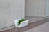 Red Otto Ottoman by Offi, versatile seating bench with integrated planter, modern design, suitable for indoor or outdoor use.