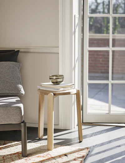 Skagerak Nomad Stool, modern wooden seating by Fritz Hansen, showcasing smooth finish and minimalist design.