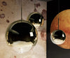Gold mirror ball pendant light by Tom Dixon, 25cm diameter, modern lighting fixture with reflective surface.