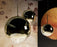Gold mirror ball pendant light by Tom Dixon, 25cm diameter, modern lighting fixture with reflective surface.