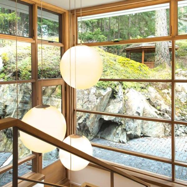 Small Globo Suspension lighting fixture by Viso, made in Canada, featuring a sleek, modern design with a rounded glass shade.