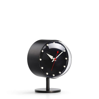 Black Vitra Night Desk Clock, a sleek accessory with a modern design, shown on a desk surface.